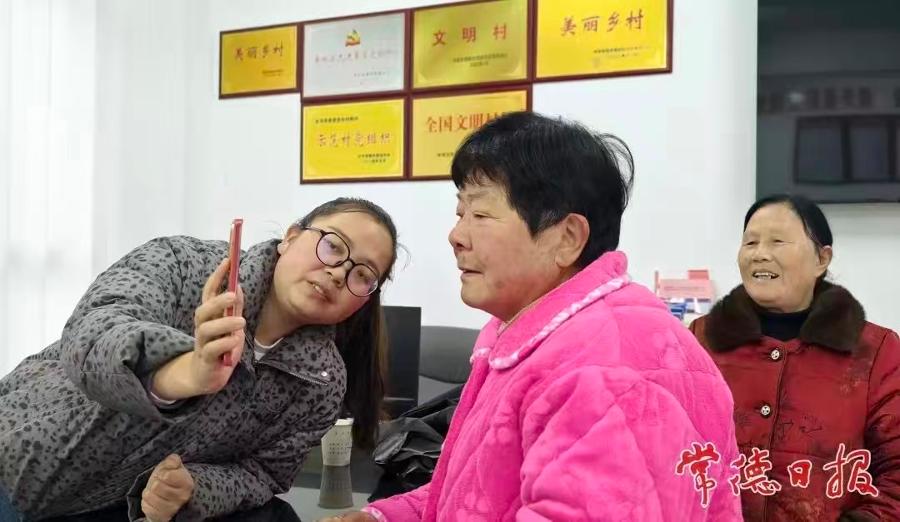 村委蔡洁为村民办养老保险（摄影作品）